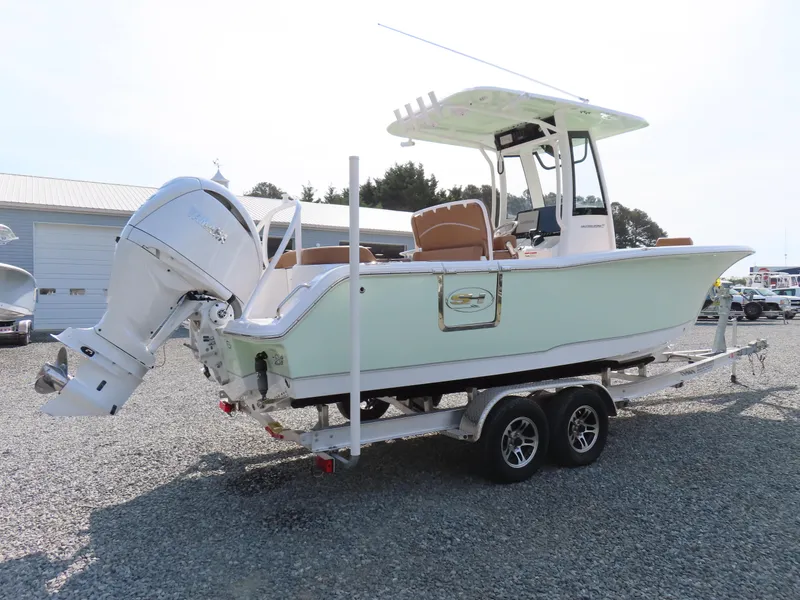 Slide: The Image of 2024 Sea Hunt Ultra 239 SE boat on trailer, side view, outdoors. - 2