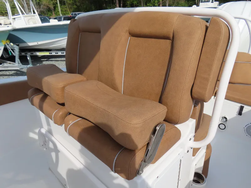 Slide: The Image of 2024 Sea Hunt Ultra 239 SE boat seating with brown cushions and white accents. - 22