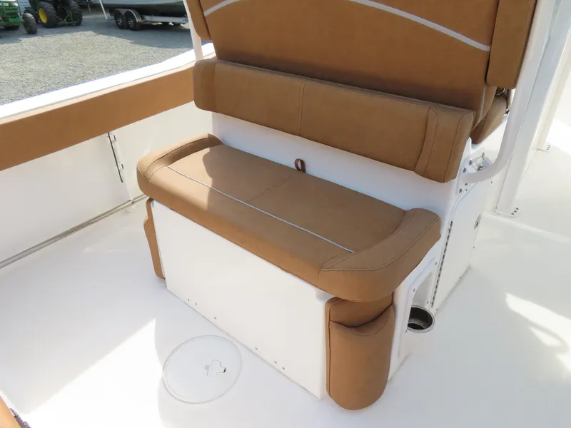 Slide: The Image of 2024 Sea Hunt Ultra 239 SE boat seating with tan cushions and white base. - 29