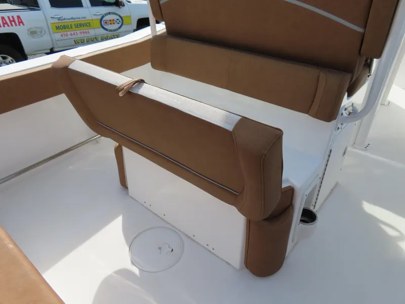 Slide: The Image of 2024 Sea Hunt Ultra 239 SE boat seating with brown upholstery. - 30