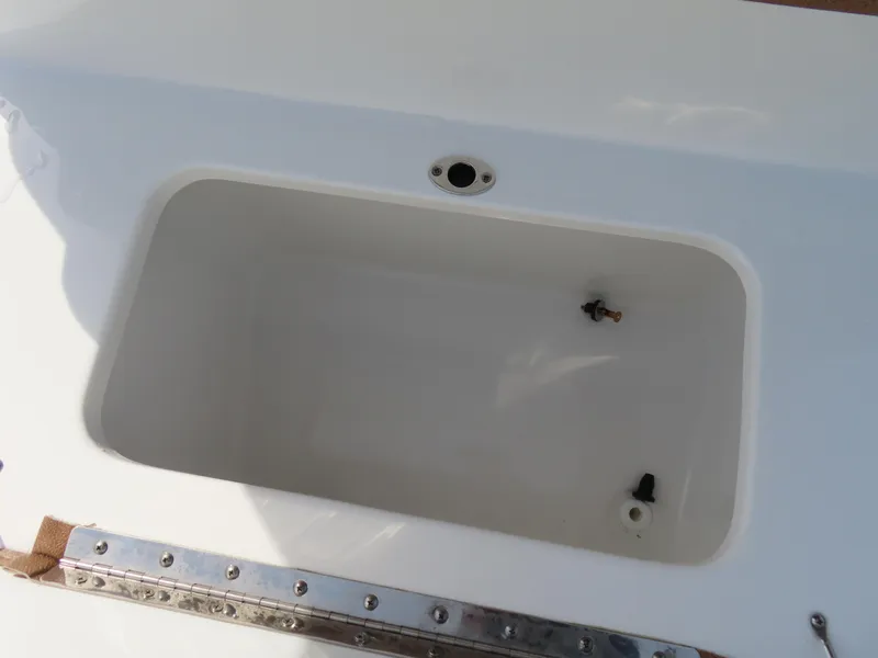 Slide: The Image of 2024 Sea Hunt Ultra 239 SE boat compartment, white interior, metal trim. - 31