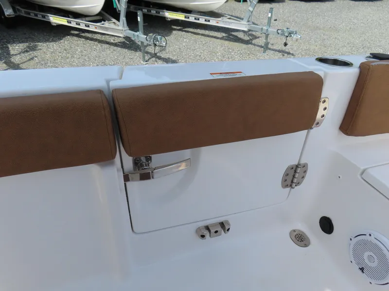 Slide: The Image of 2024 Sea Hunt Ultra 239 SE boat interior with cushioned seating and storage compartment. - 32