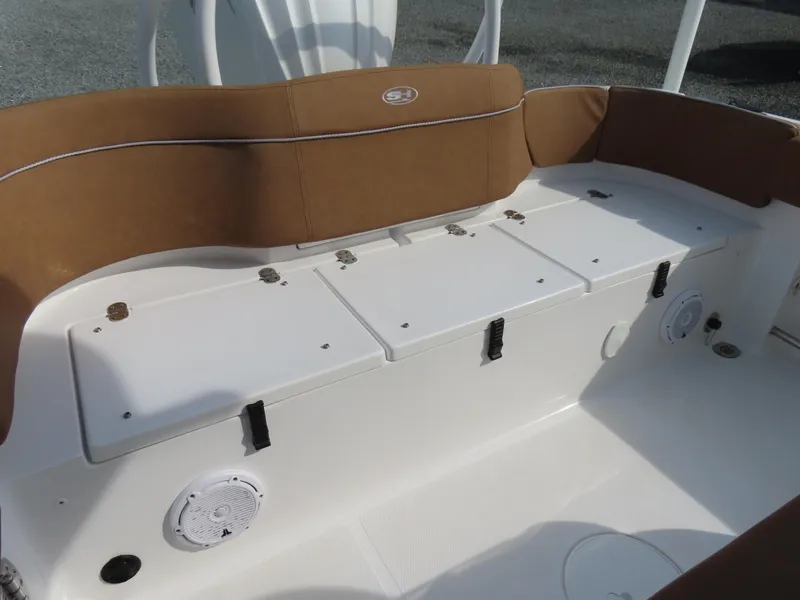 Slide: The Image of 2024 Sea Hunt Ultra 239 SE boat seating area with storage compartments and speakers. - 35
