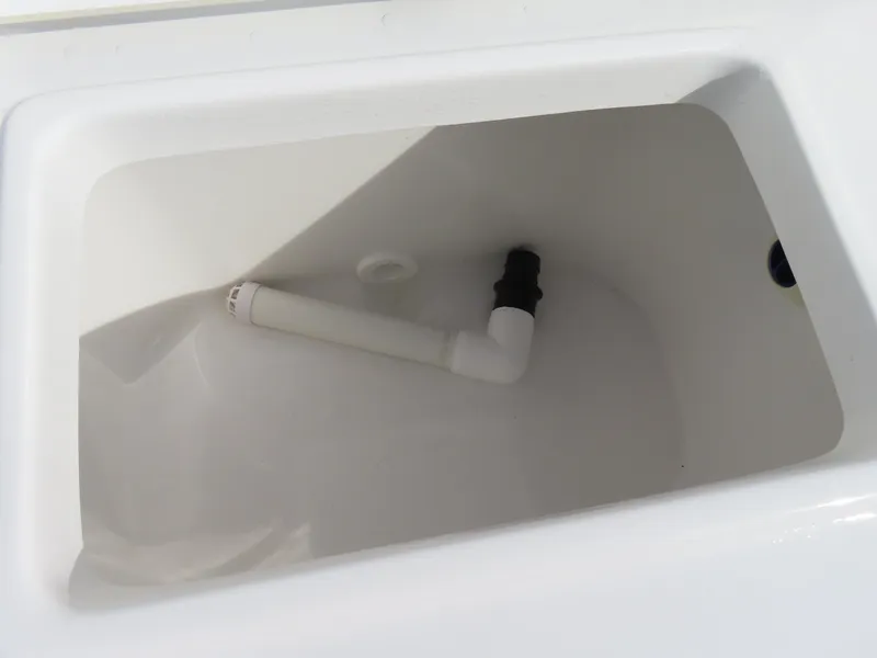 Slide: The Image of 2024 Sea Hunt Ultra 239 SE boat compartment with drainage pipe. - 38
