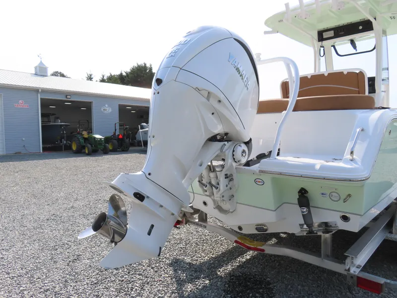 Slide: The Image of 2024 Sea Hunt Ultra 239 SE boat with Yamaha outboard motor in a marina setting. - 5