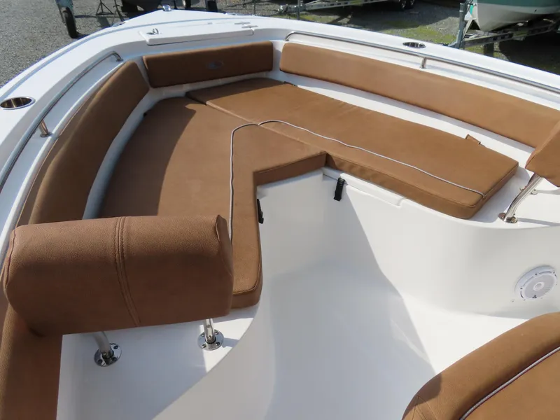 Slide: The Image of 2024 Sea Hunt Ultra 239 SE boat with brown cushioned seating area. - 7
