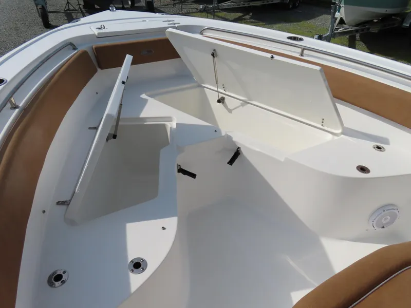 Slide: The Image of 2024 Sea Hunt Ultra 239 SE boat with open storage compartments. - 9