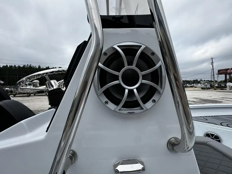 Slide: The Image of 2025 Xpress H24B boat speaker detail with stainless steel railing, overcast sky background. - 2
