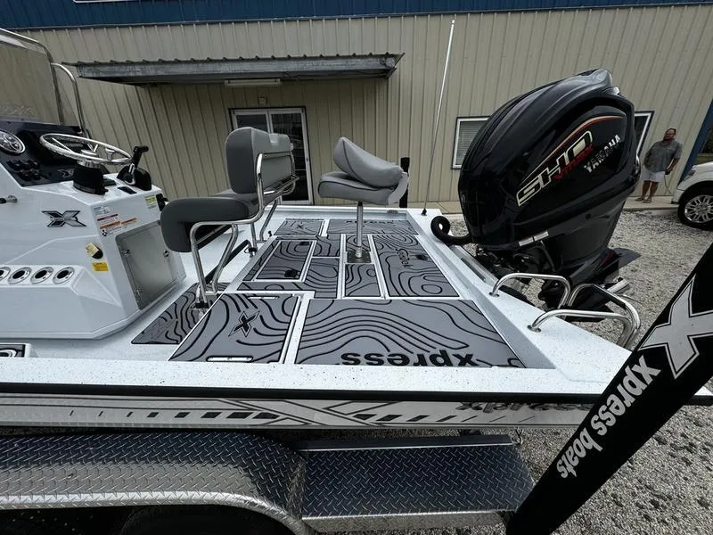 Slide: The Image of 2025 Xpress H24B boat with detailed deck design and powerful outboard motor. - 3