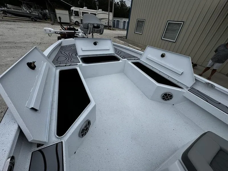 Slide: The Image of 2025 Xpress H24B boat interior with open storage compartments and speakers. - 4