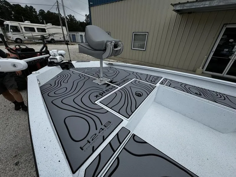 Slide: The Image of 2025 Xpress H24B boat with custom deck design, featuring a swivel seat and modern detailing. - 6