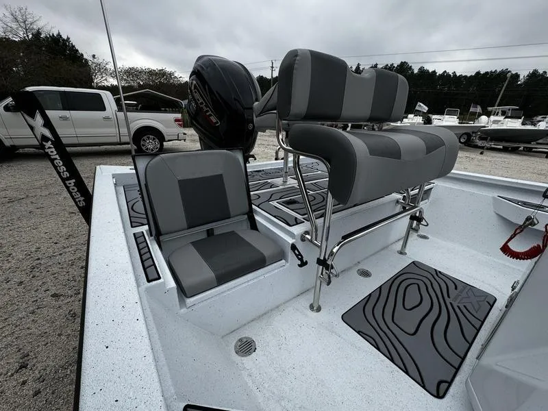 Slide: The Image of 2025 Xpress H24B boat interior with gray seating and modern design. - 7