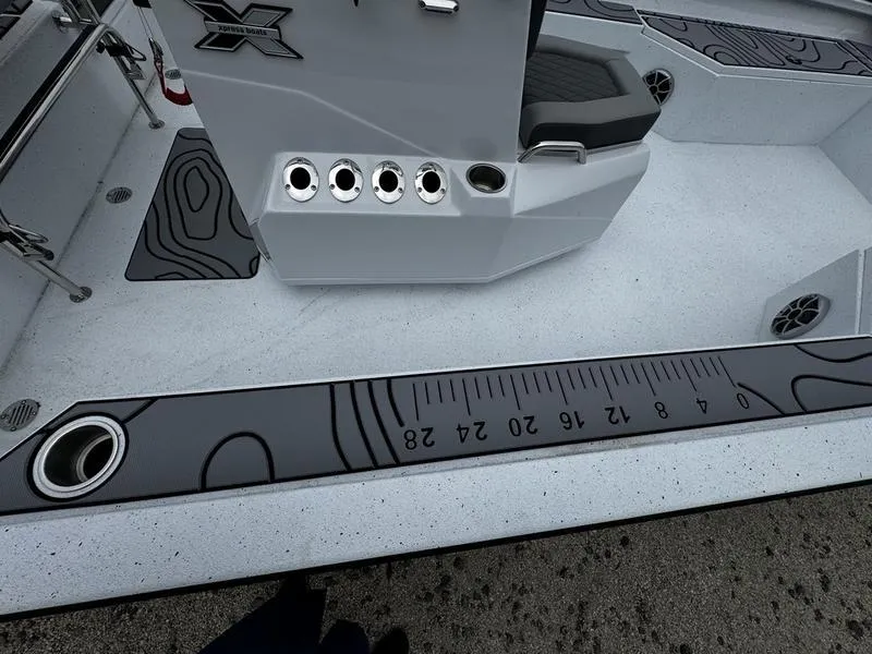 Slide: The Image of 2025 Xpress H24B boat interior with ruler design and seating area. - 8