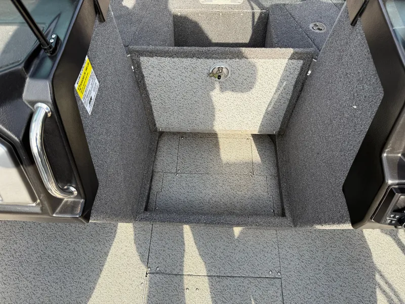 Slide: The Image of 2023 Lund 2275 Baron boat interior with carpeted flooring and storage compartment. - 11