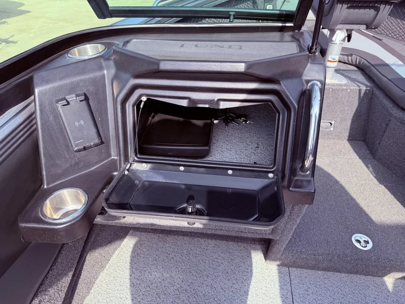 Slide: The Image of 2023 Lund 2275 Baron boat interior storage compartment with cup holders and sleek design. - 20
