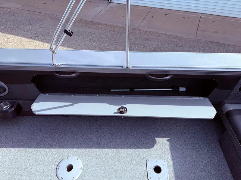 Slide: The Image of 2023 Lund 2275 Baron boat interior storage compartment with open hatch. - 23