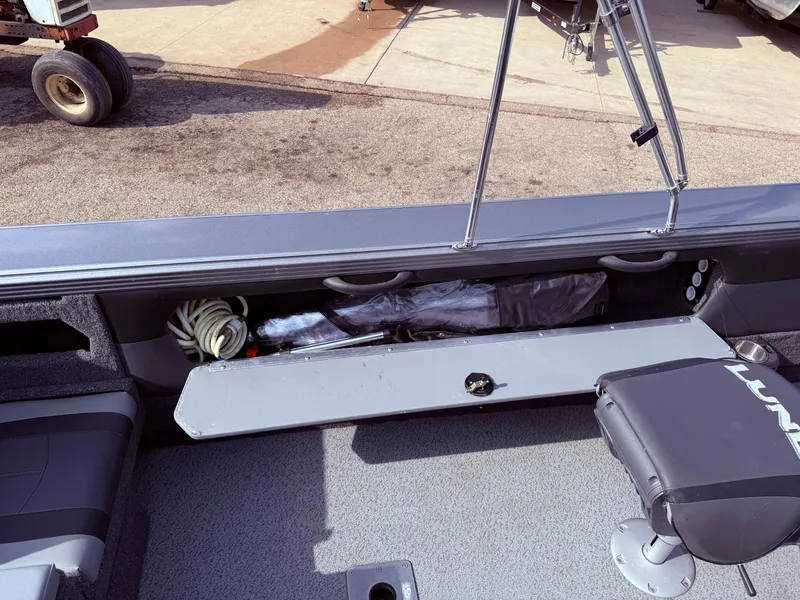 Slide: The Image of 2023 Lund 2275 Baron boat interior with open storage compartment and seating. - 24
