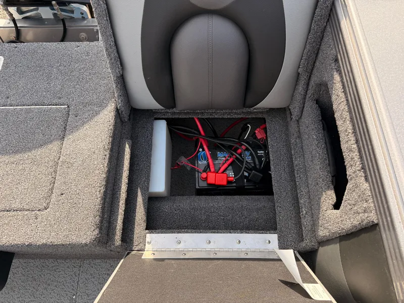 Slide: The Image of 2023 Lund 2275 Baron boat battery compartment with wiring and storage. - 27