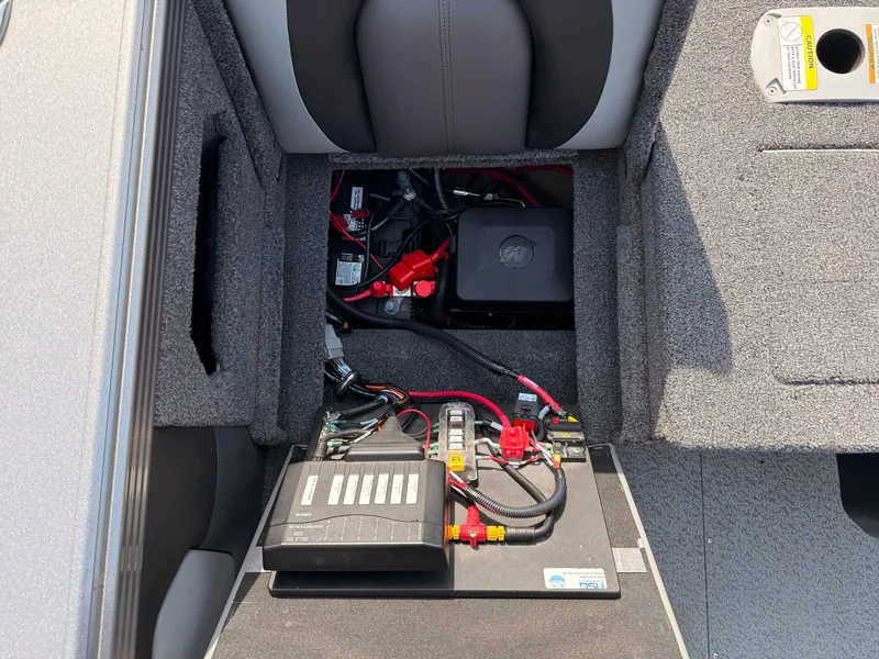 Slide: The Image of 2023 Lund 2275 Baron boat battery compartment with wiring and components. - 28