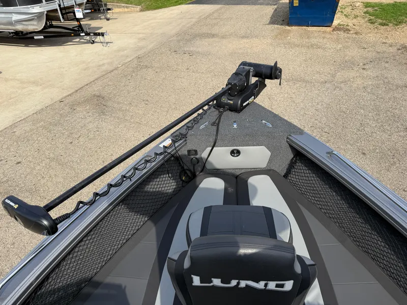Slide: The Image of 2023 Lund 2275 Baron boat interior with trolling motor, featuring sleek seating and storage. - 7