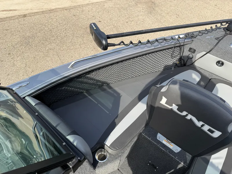 Slide: The Image of 2023 Lund 2275 Baron boat interior with seating and fishing equipment. - 8