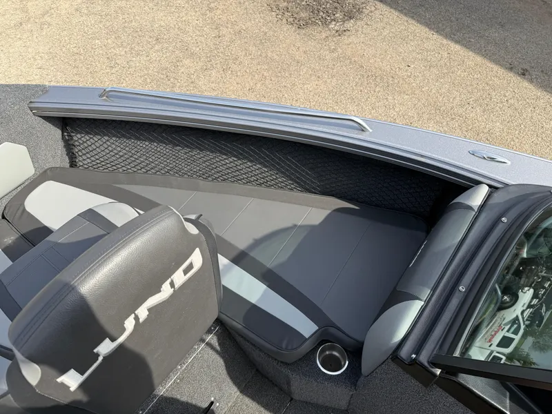 Slide: The Image of 2023 Lund 2275 Baron boat interior with gray seating and storage compartments. - 9