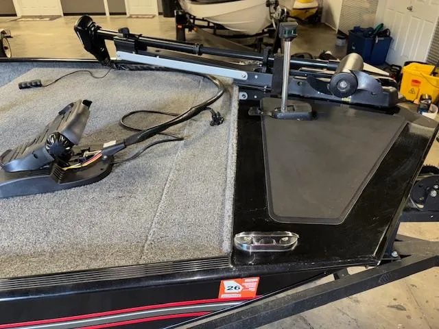 Slide: The Image of 2023 Bass Tracker Classic XL boat interior with fishing equipment and carpeted deck. - 12