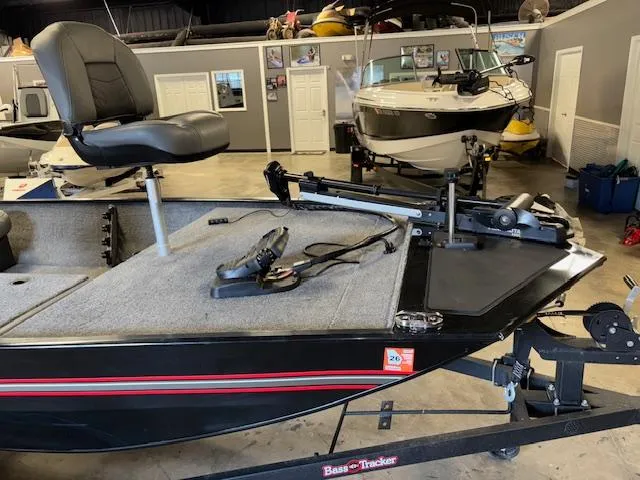 Slide: The Image of 2023 Bass Tracker Classic XL boat in showroom, featuring seating and equipment. - 13