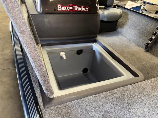 Slide: The Image of 2023 Bass Tracker Classic XL boat interior with open storage compartment. - 16