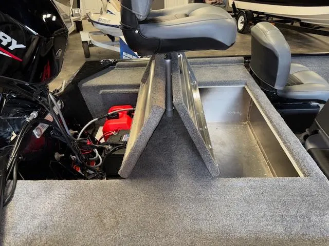 Slide: The Image of 2023 Bass Tracker Classic XL boat interior with open storage compartments and seating. - 17