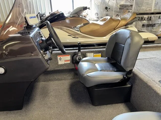 Slide: The Image of 2023 Bass Tracker Classic XL boat interior with steering wheel and seat. - 18