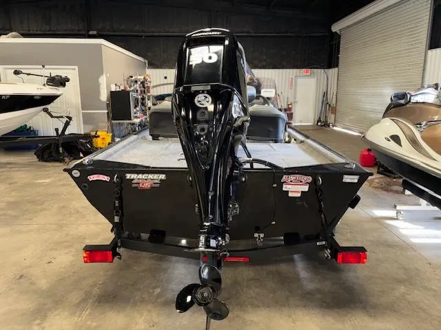Slide: The Image of 2023 Bass Tracker Classic XL boat in a garage, rear view with motor. - 7
