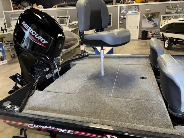 Slide: The Image of 2023 Bass Tracker Classic XL boat with Mercury engine in showroom. - 9
