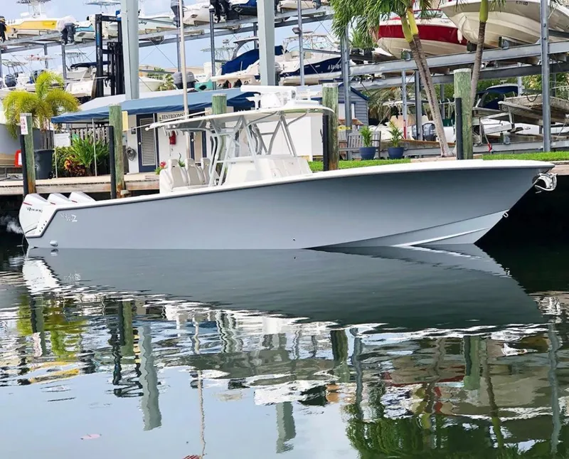The Image of 2020 SeaVee 370z boat docked in a marina, reflecting on calm water. - 1