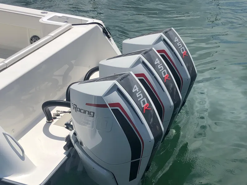 Slide: The Image of Four powerful outboard motors on a 2020 SeaVee 370z boat in water. - 3