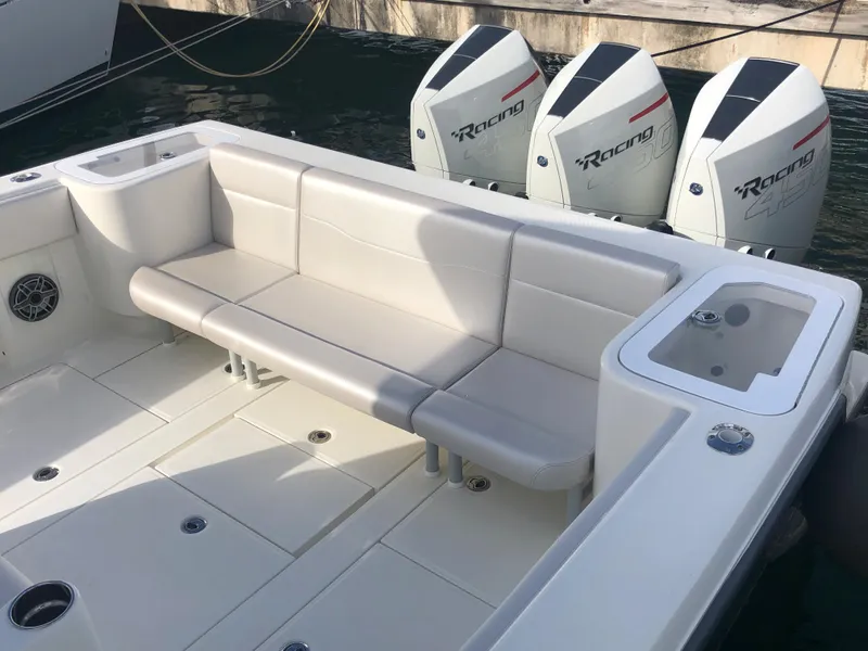 Slide: The Image of 2020 SeaVee 370z boat with triple outboard engines and spacious seating area. - 8