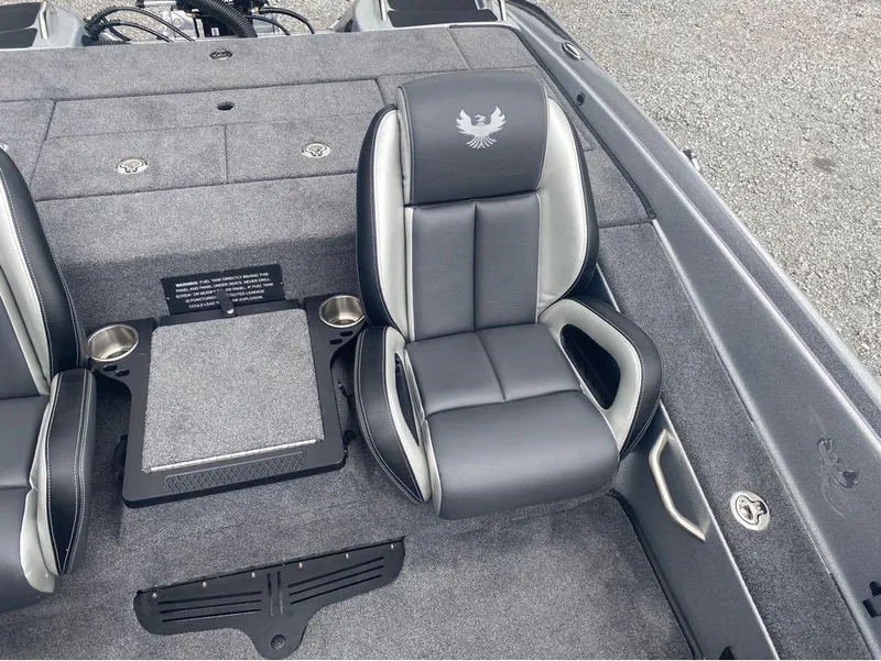 Slide: The Image of 2025 Phoenix 518 Pro boat interior with gray and black seating, cup holders, and storage compartments. - 10