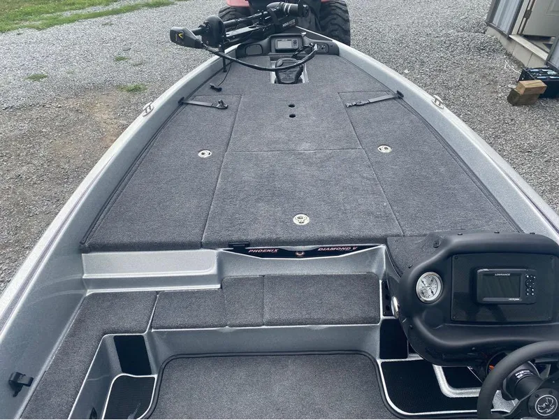 Slide: The Image of 2025 Phoenix 518 Pro boat interior with carpeted deck and control panel. - 11