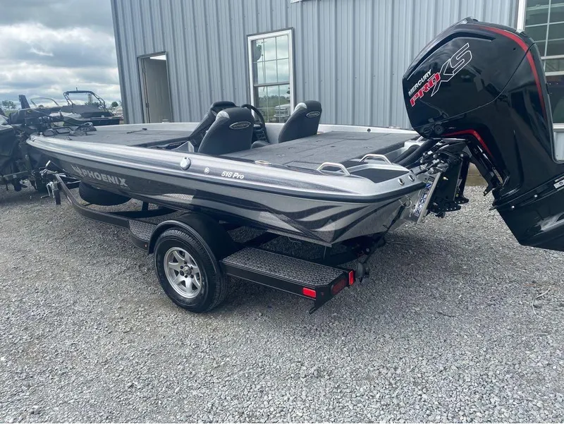 Slide: The Image of 2025 Phoenix 518 Pro boat with Mercury Pro XS engine, parked on gravel. - 17