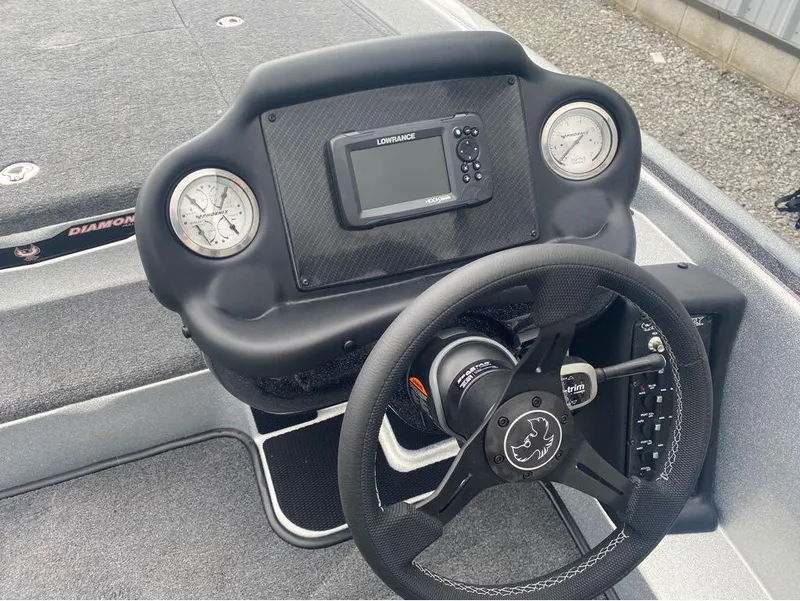 Slide: The Image of 2025 Phoenix 518 Pro boat dashboard with steering wheel, gauges, and Lowrance display. - 18