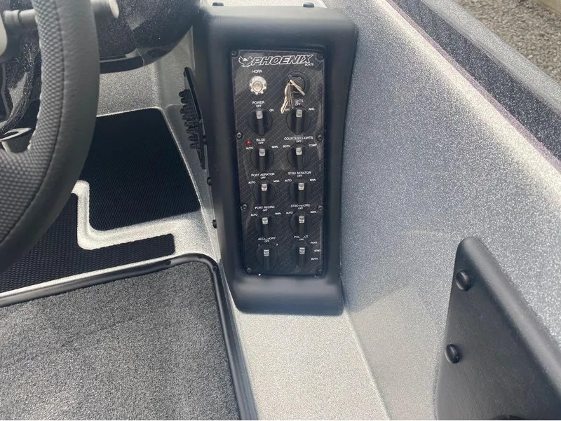 Slide: The Image of Control panel of 2025 Phoenix 518 Pro boat with switches and steering wheel. - 4