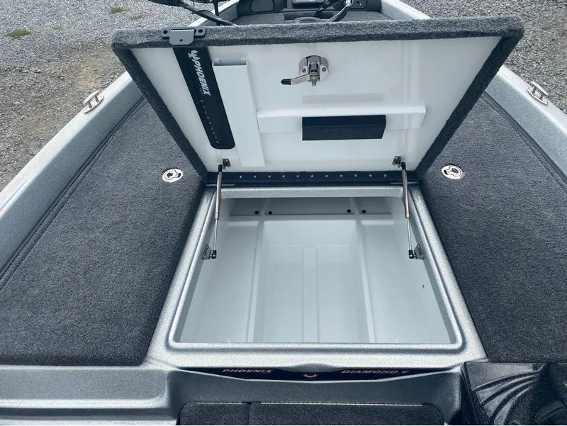Slide: The Image of Open storage compartment in 2025 Phoenix 518 Pro boat, featuring carpeted interior and hydraulic lift. - 5