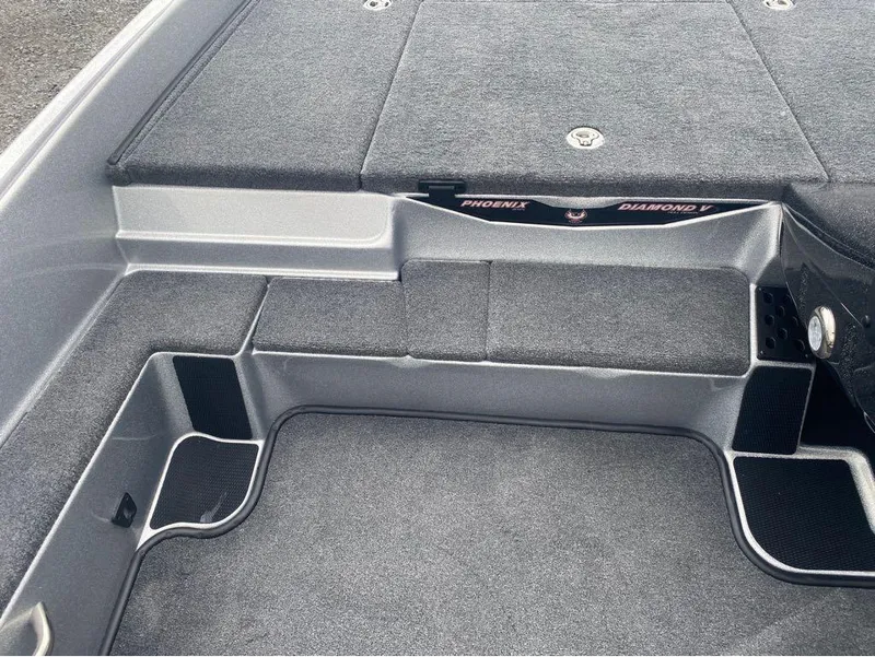 Slide: The Image of Interior of 2025 Phoenix 518 Pro boat, featuring carpeted flooring and storage compartments. - 8