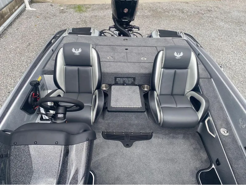 Slide: The Image of 2025 Phoenix 518 Pro boat interior with dual seats and steering wheel, on gravel surface. - 9