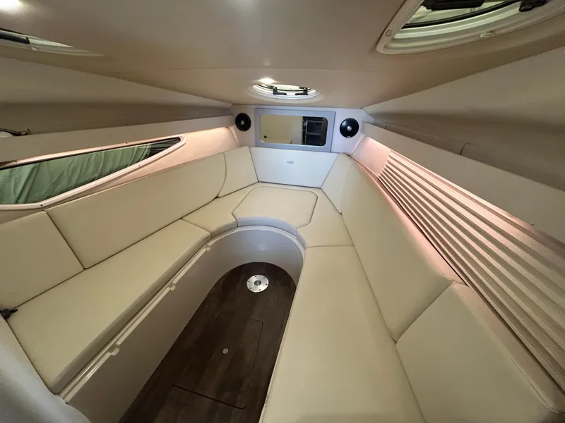 Slide: The Image of Luxurious interior of 2021 Regal 2800 Express boat with beige seating and wood flooring. - 15