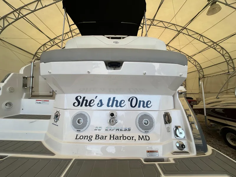 Slide: The Image of 2021 Regal 2800 Express boat with "She's the One" text, docked at Long Bar Harbor, MD. - 2