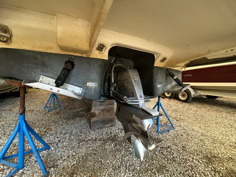 Slide: The Image of 2021 Regal 2800 Express boat on stands, showing propeller and stern drive. - 3