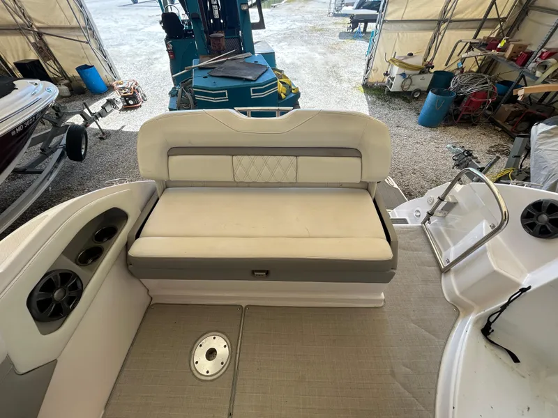 Slide: The Image of 2021 Regal 2800 Express boat interior with cushioned seating and speaker system. - 4