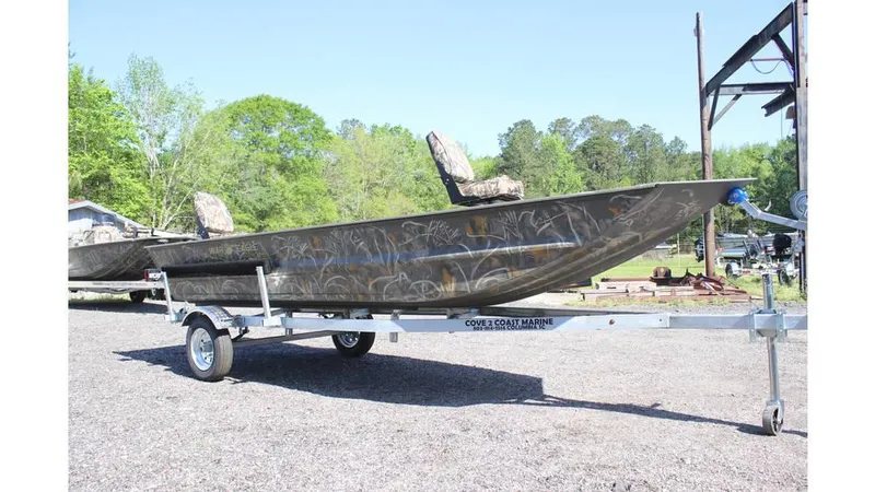 Slide: The Image of 2025 War Eagle 648LDV Sportsman boat on trailer, outdoors, with camouflage design. - 9