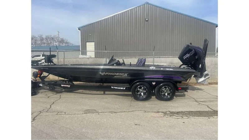 Slide: The Image of 2025 Phoenix 920 Elite boat on trailer, parked near industrial building. - 1